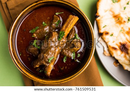 Mutton OR Gosht Masala OR indian lamb rogan josh with some seasoning, served with Naan or Roti, selective focus
