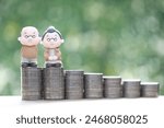 Mutual fund,Love couple senior and stack of coins money on natural green background, Save money for prepare in future and pension retirement concept