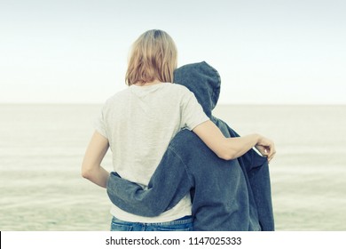 Mutual Understanding Between The Parent And The Child. Mother And Daughter Teenager Embrace On The Seashore, Ocean.