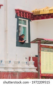 Muya five buddhist institute, Kangding, Sichuan - May 2021: Unidentified tibetan lamas reading books and study, novice monks, student of Buddhist school at Muya monastery