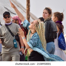 MUYNAQ, UZBEKISTAN - MAY 07: Raver in blue ethnic textiles dances on the Progressive Stage at Stihia Music festival on May 07, 2022 in Muynaq, Uzbekistan