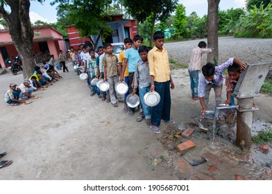 Muzaffarpur, Bihar, India,  25th July 2013: Student Washing  Their Food Plate Others Are Waiting In Queue During Mid Day Meal Lunch Break In Secondary School Of Rural India. 