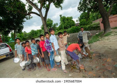 Muzaffarpur, Bihar, India,  25th July 2013: Student Washing  Their Food Plate Others Are Waiting In Queue During Mid Day Meal Lunch Break In Secondary School Of Rural India. 