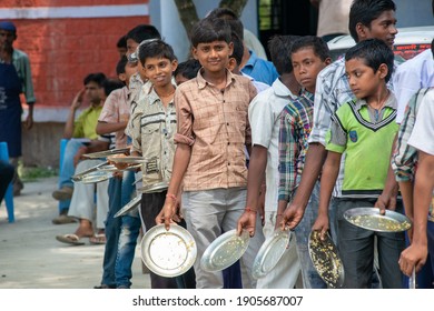 Muzaffarpur, Bihar, India,  25th July 2013: Student Washing  Their Food Plate Others Are Waiting In Queue During Mid Day Meal Lunch Break In Secondary School Of Rural India. 