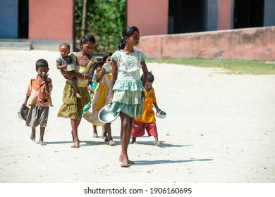 Muzaffarpur, Bihar, India,  25th July 2013: Indian Poor Kids Coming To School With Food Plates  For Free Mid Day Meal At A Government School,  Mid Day Meal Scheme In Bihar.