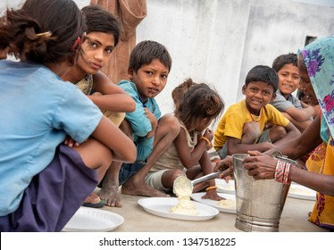 Muzaffarpur, India -  March 15, 2019: Poor young kids having their meal. 