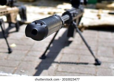 The muzzle of automatic rifle close-up on blurred background in real conditions