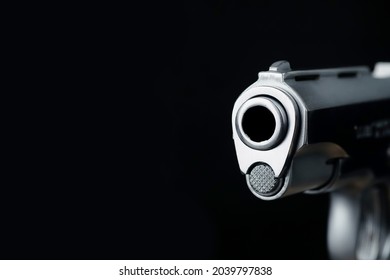 The muzzle part of the pistol scene on a black background represents a concept related to the concept of abstract weapons.