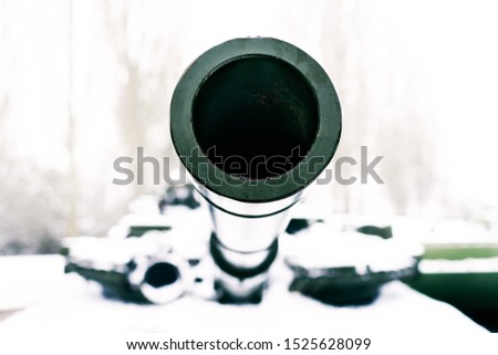 Muzzle of the tank in winter closeup, selective focus. Tank gun barrel