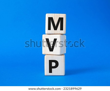 MVP - Most Valuable Player symbol. Wooden cubes with words MVP. Beautiful blue background. Business and MVP concept. Copy space.