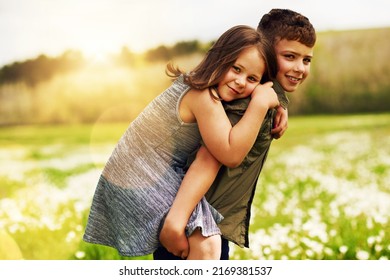 My big brother is my hero. Portrait of an adorable little boy giving his little sister a piggyback ride outside. - Shutterstock ID 2169381537