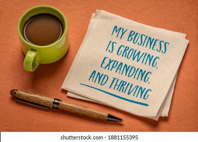 my business is growing, expanding, and thriving - handwriting on a napkin with a cup of coffee, positive affirmation for business owners