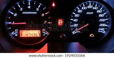 My car speedo mileage meter in the dark of the night