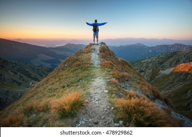 My country, my home. Man on top of mountain massif. Idyllic evening - a man on the ridge of the Low Tatras at sunset. Self Portrait in a mountain area. - Powered by Shutterstock