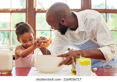 My Dad Is My Superman. Shot Of An Adorable Little Girl And Her Father Bonding By Baking In The Kitchen At Home.