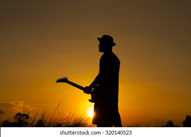 My dream the guitar man on silhouette sunset background