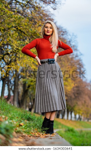 It is my fall style. Clothing features. Must have\
skirt. Trendy girl wear midi skirt. Pleated skirt collection.\
Blonde enjoy cozy outfit nature background. Inspiring outfit.\
Femininity natural beauty.