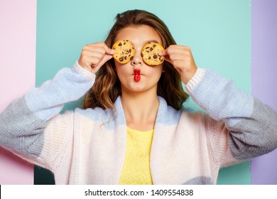 My favorite cookies. Pretty girl covering eyes with cookies. Bakery style chocolate chip cookie recipe. Cute girl having fun with cookies. Following a cooking recipe. Bakery shop. - Powered by Shutterstock