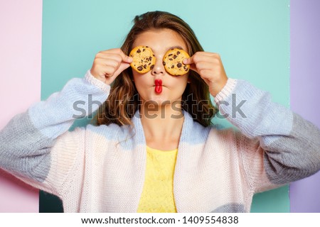 My favorite cookies. Pretty girl covering eyes with cookies. Bakery style chocolate chip cookie recipe. Cute girl having fun with cookies. Following a cooking recipe. Bakery shop.
