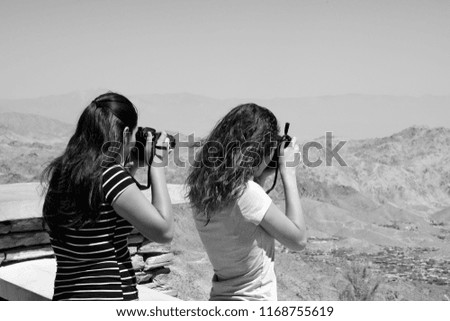 My granddaughters taking pictures of the Coachella Valley from a vista point.