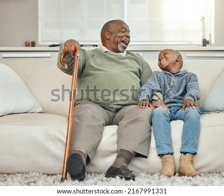 My grandpas the coolest. Shot of a grandfather bonding with his young grandson on a sofa at home.