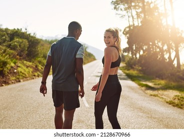 My Guy Makes The Best Workout Buddy. Shot Of A Fit Young Couple Slowing Down For A Walk During Their Run Outdoors.