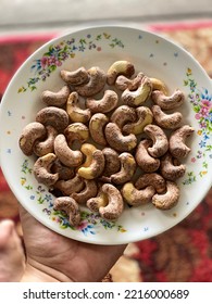 My Hand Was Holding A Plate Full Of Fried Cashew Nuts For Afternoon Snack