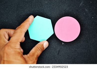 In my hands is a business connecting piece of coloured hexagon and round wood chart.