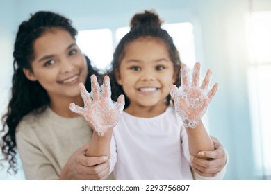 My hands are as happy as I am. Shot of a little girl and her mother washing their hands in a bathroom at home.