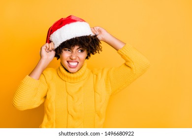 My Head Is Too Big For This Red Hat! Photo Of Annoyed Irritated Girl Trying To Wear Small Hat With White Fur On Her Volume Hairdo Holding Hands Isolated Bright Background