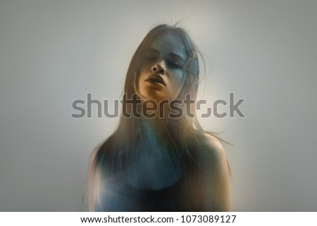 Similar – a girl with blue eyes and long hair covering herself with a gerbera flower