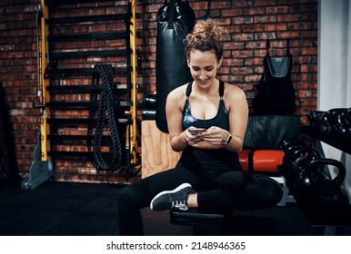 My Medical Aid Rewards Me Every Time I Work Out. Shot Of A Sporty Young Woman Using A Digital Tablet While Sitting In The Gym.