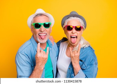 My parents are crazy! Music lovers rock fans concept youth concept. Close up photo portrait of excited funky funny comic cheerful guy and lady making stick tongue out sign isolated bright background