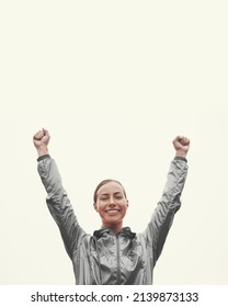 My Personal Best. Shot Of A Young Woman Standing With Her Arms Raised In Victory While Out For An Early Morning Run.