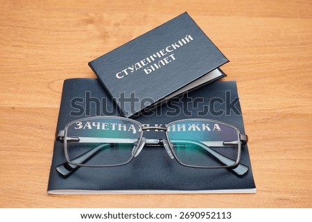 My student ID, transcript, and glasses are on the table                