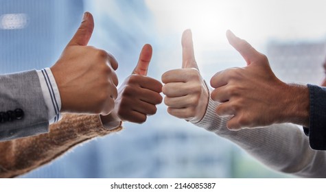 With My Team At My Side I Am Unstoppable. Shot Of A Group Of People Giving The Thumbs Up.