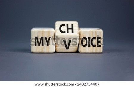 My voice choice symbol. Businessman turns wooden cubes and changes the concept word My choice to My voice. Beautiful grey table grey background, copy space. Business and my voice choice concept