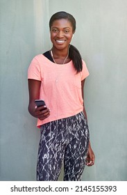 My Workout Playlist. Shot Of An Attractive Young Woman Exercising Outdoors.