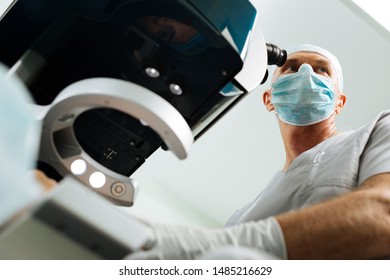 At my workplace. Low angle of an adult male doctor wearing a mask while standing near the microscope - Shutterstock ID 1485216629