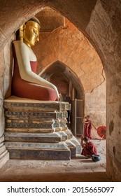 Myanmar, Bagan. Novice Buddhist Monks At Buddha Statue.