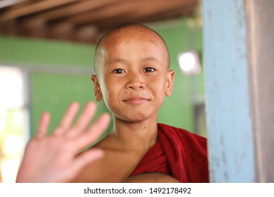 Myanmar Burma August 2019. Student Buddhist Monk Waving Through Window