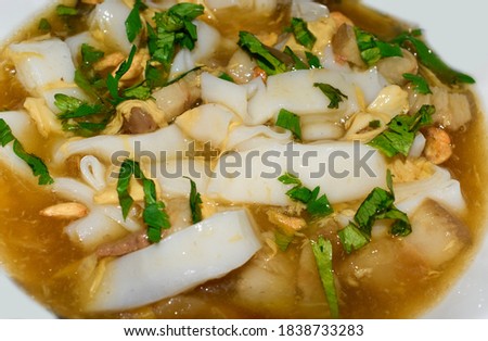 Myanmar homemade Lor Mee recipe. Lor mee is a Chinese, Indonesian or Malaysian noodle dish served in thick starchy gravy and flat yellow noodles. Closeup view.