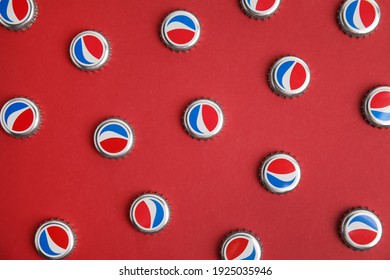 MYKOLAIV, UKRAINE - FEBRUARY 11, 2021: Pepsi lids on red background, flat lay