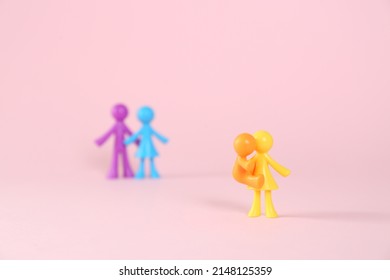 MYKOLAIV, UKRAINE - JANUARY 04, 2022: Colorful Human Figures On Pink Background. Surrogacy Concept