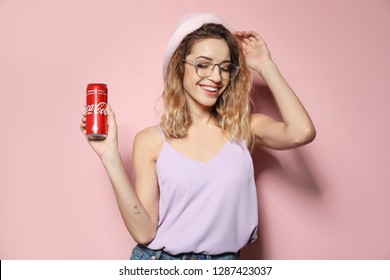 MYKOLAIV, UKRAINE - NOVEMBER 28, 2018: Young woman with Coca-Cola can on color background