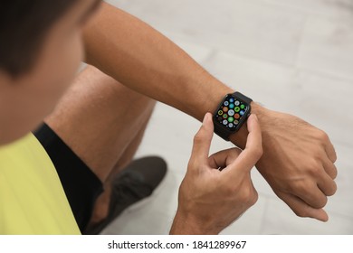 MYKOLAIV, UKRAINE - OCTOBER 04, 2019: Man Using Apple Watch At Home, Closeup