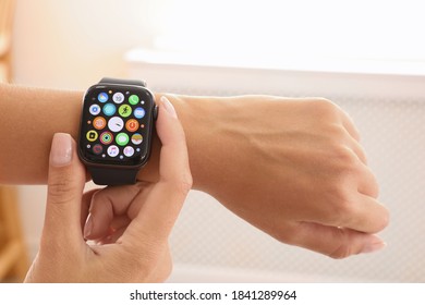 MYKOLAIV, UKRAINE - SEPTEMBER 19, 2019: Woman Using Apple Watch At Home, Closeup