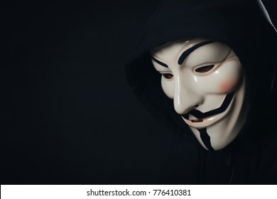 MYKOLAIV, UKRAINE - SEPTEMBER 29, 2017: Anonymous person in Guy Fawkes mask on black background