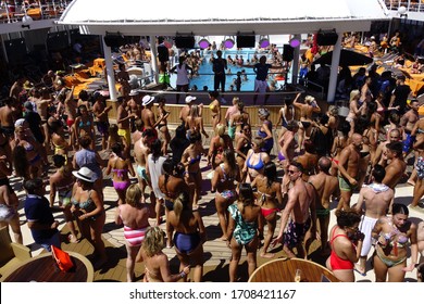 Mykonos / Greece - 08/22/2019: Crowd Of Passengers Dancing During A Pool Party On Board A Cruise Ship