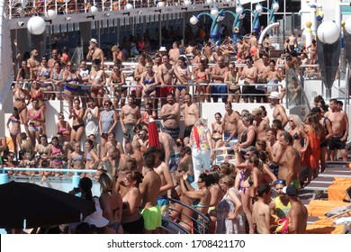 Mykonos, Greece - 08.22.2019: Cruise Ship Deck Full Of Tourists Dancing During A Pool Party On Board A Cruise Ship